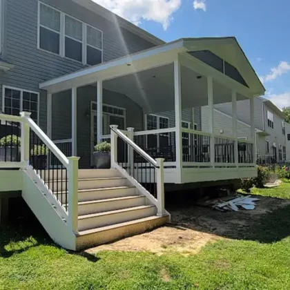 Photo of covered deck with steps and railing