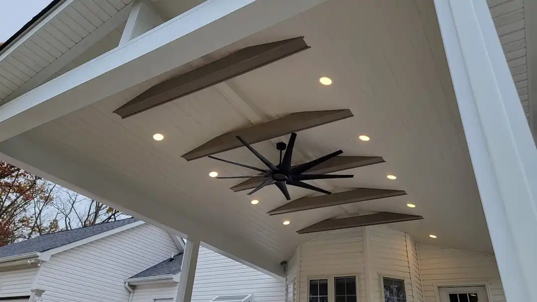 Photo of a custom designed covered porch features including lights and ceiling fan.