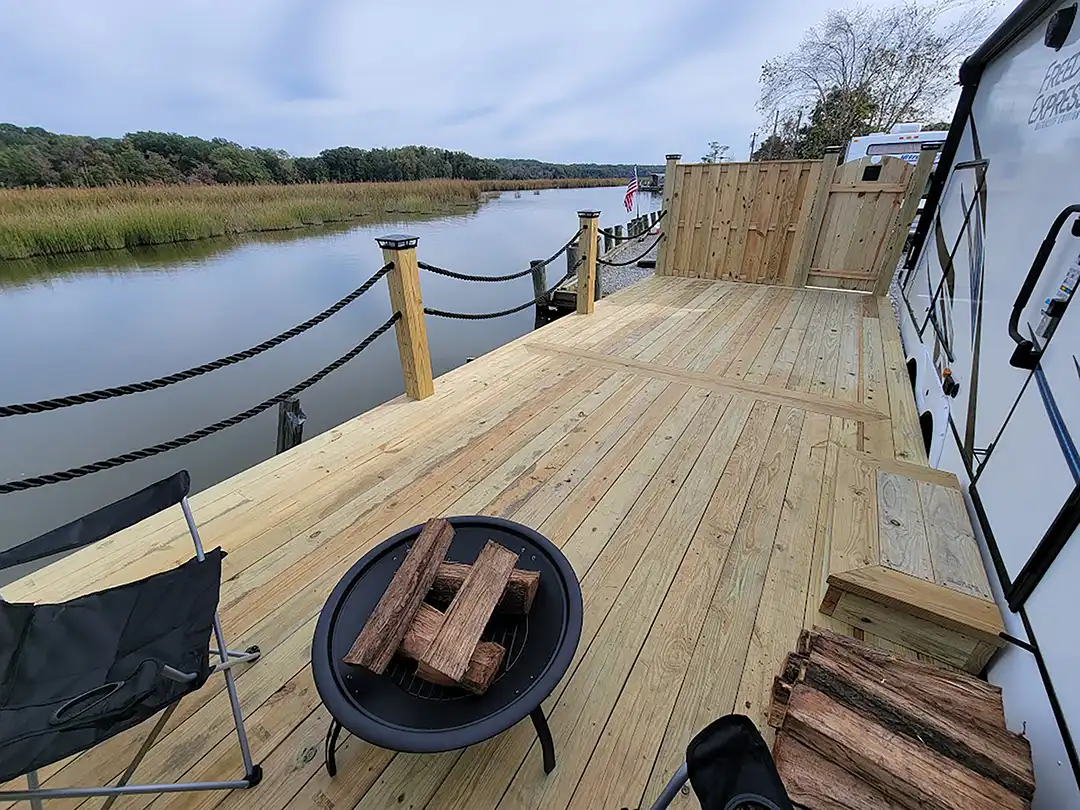 Photo of a waterfront custom deck with rope railing. Custom deck design