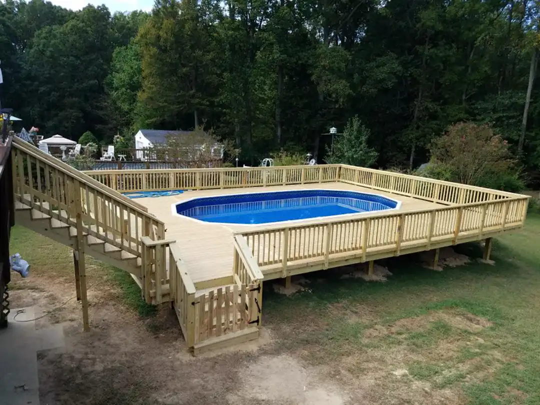 Photo of a multi-level deck that leads down to a pool deck. Custom deck design