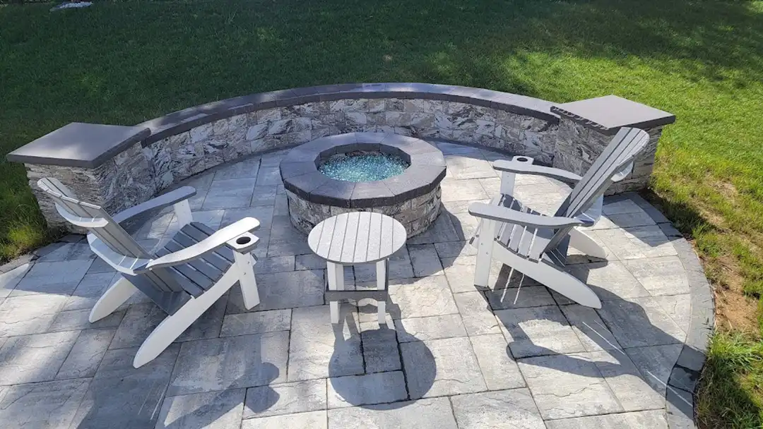 Photo of a paver patio with fire pit and built-in seating wall