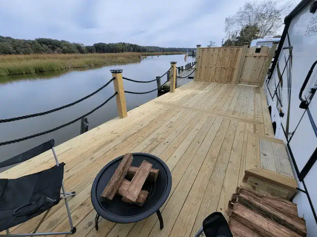 Photo of - wood deck along the waterfront - keep your deck project on budget - deck building company near me in southern maryland