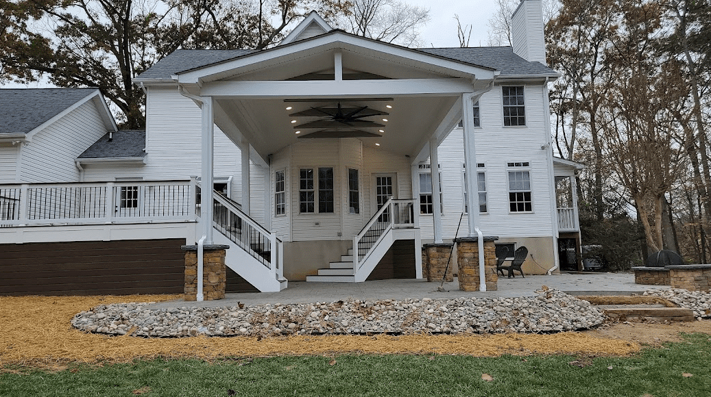 Photo of a grand porch that is covered, includes a deck and patio - porch design ideas