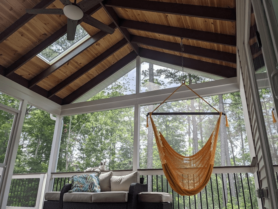 Photo of covered and screened porch with skylights and furniture - porch design ideas