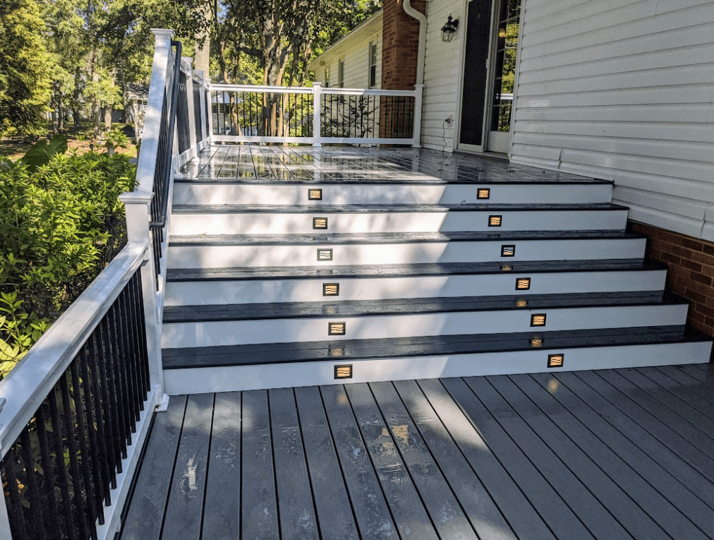 Photo of a multi-level composite deck with integrated recessed lighting in the steps - Deck Lighting options and composite deck ideas