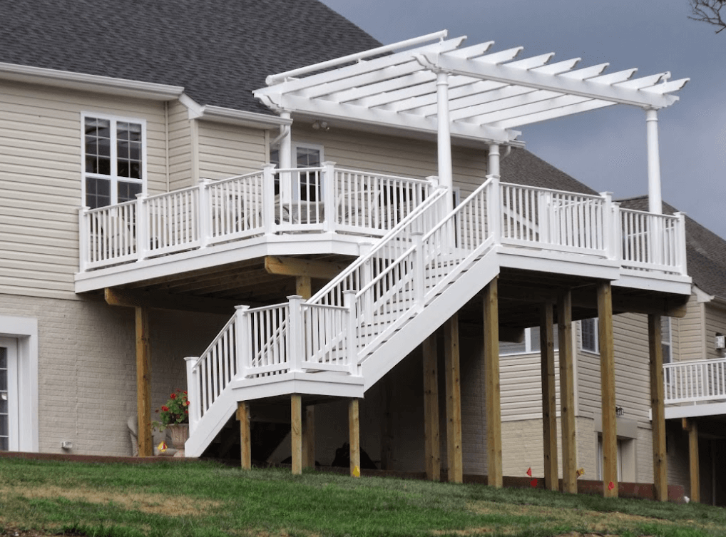 photo of a white pergola on an elevated deck with white deck railing and steps - Pergola ideas for a composite deck